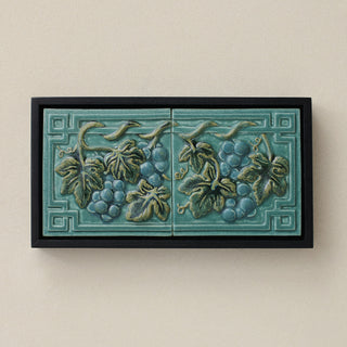 Sculpted decorative tile in wood frame by Rookwood