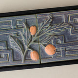 Close-up details of the sculpted tile, with visible carvings and layered glaze.