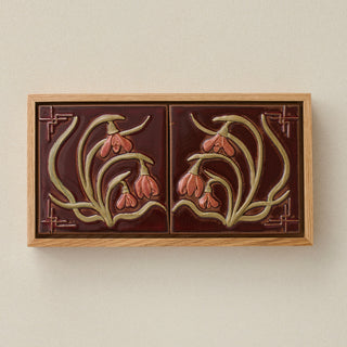 Sculpted decorative tile in wood frame by Rookwood