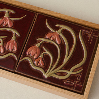 Close-up details of the sculpted tile, with visible carvings and layered glaze.