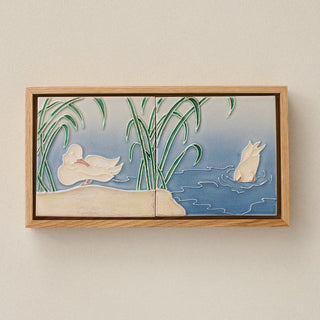 Sculpted decorative tile in wood frame by Rookwood