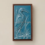 Sculpted decorative tile in wood frame by Rookwood