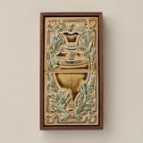 Sculpted decorative tile in wood frame by Rookwood