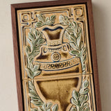 Close-up details of the sculpted tile, with visible carvings and layered glaze.