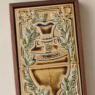 Close-up details of the sculpted tile, with visible carvings and layered glaze.