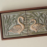 Close-up details of the sculpted tile, with visible carvings and layered glaze.