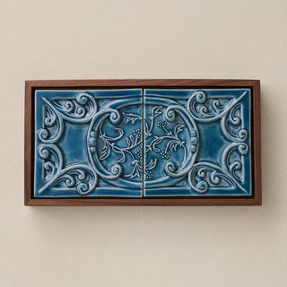 Sculpted decorative tile in wood frame by Rookwood