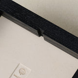 Back of wood frame with notch for easy hanging.