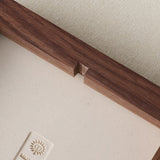 Back of wood frame with notch for easy hanging.